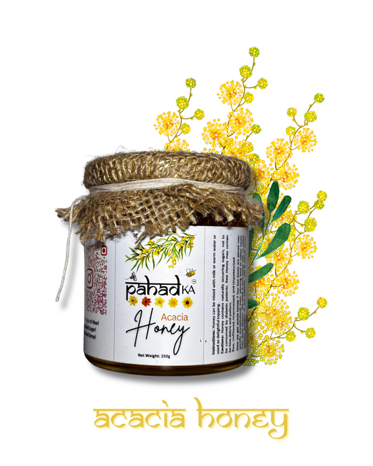 Jar of acacia honey with a decorative label and flowers on a white background
