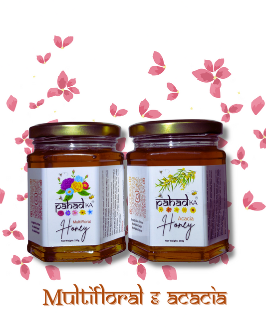 Two jars of honey with floral decorations on a white background